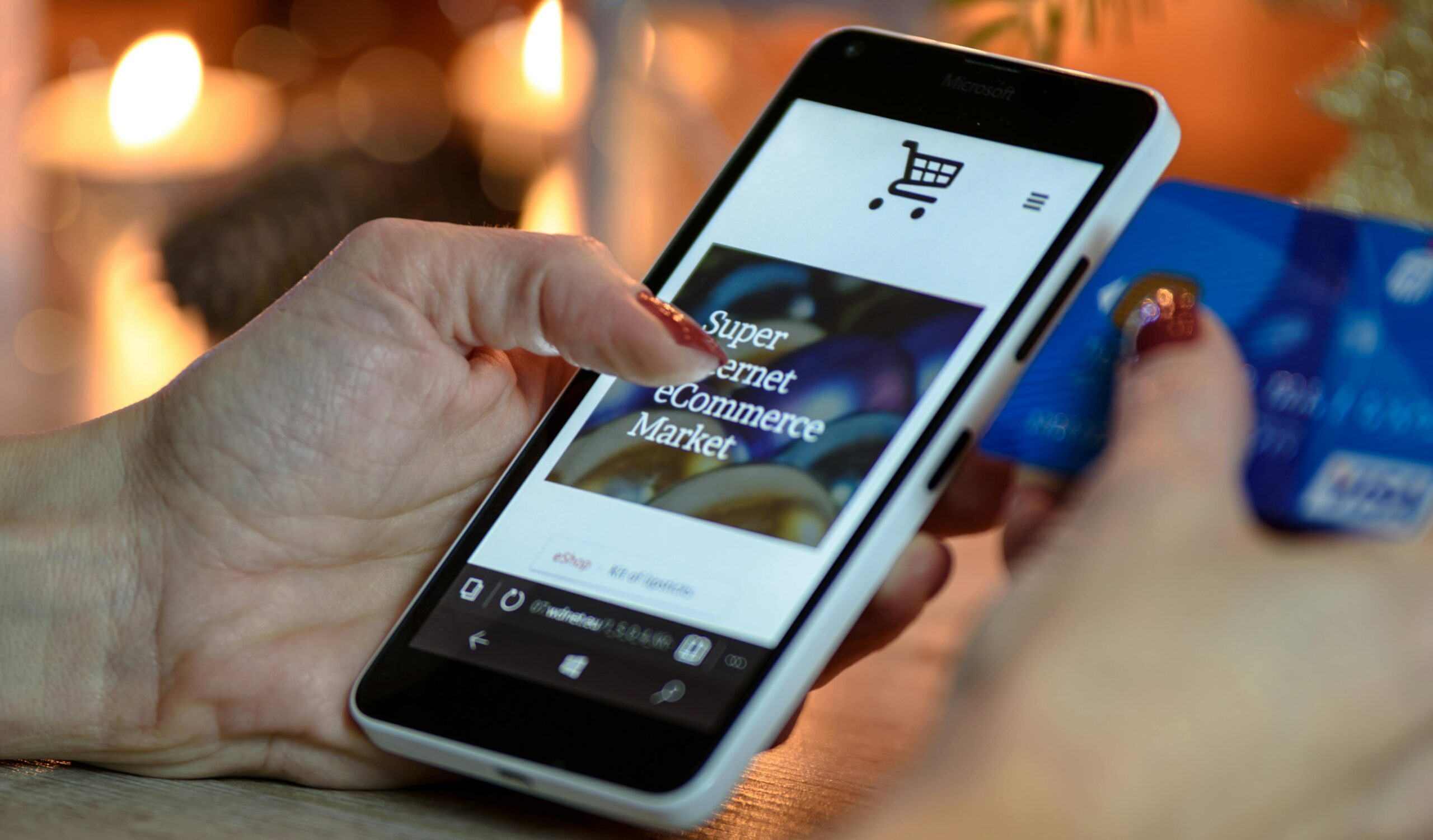 Person using smartphone and credit card to shop online, illustrating retail marketing automation and digital retail media marketing solutions.